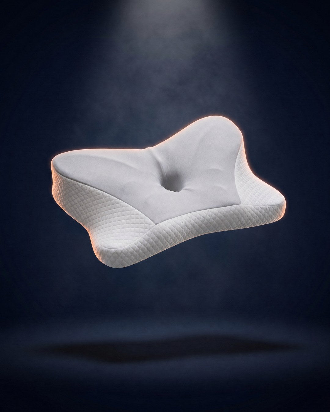 The WakeWell contour pillow floating in a spotlight