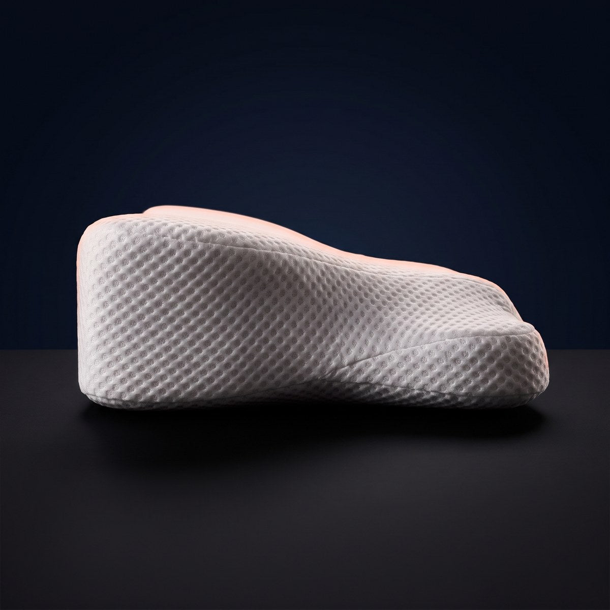 Side profile of the WakeWell pillow showing its high and low edges